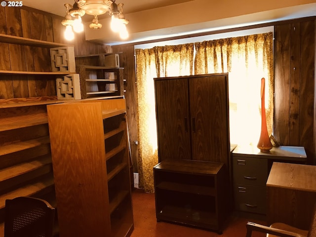 walk in closet featuring a chandelier
