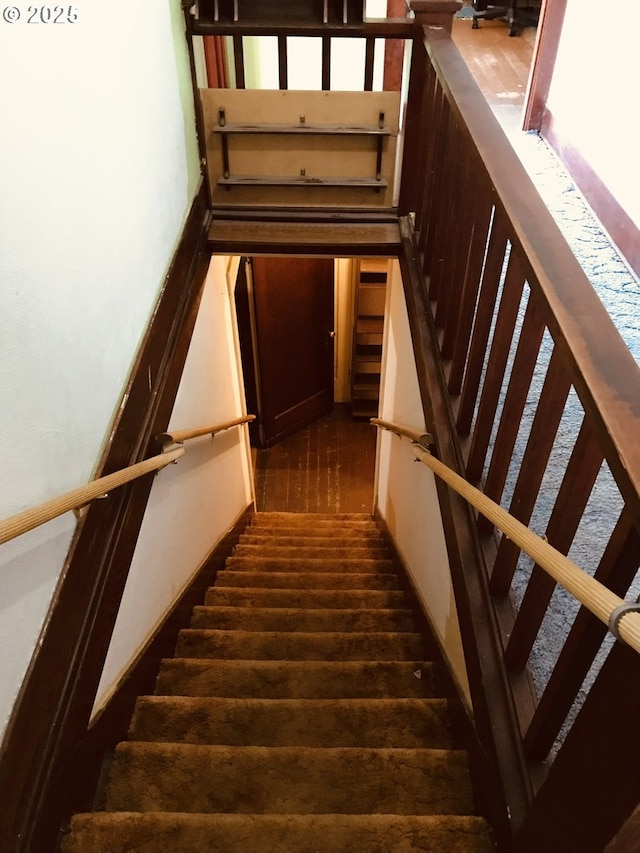 stairway with wood finished floors
