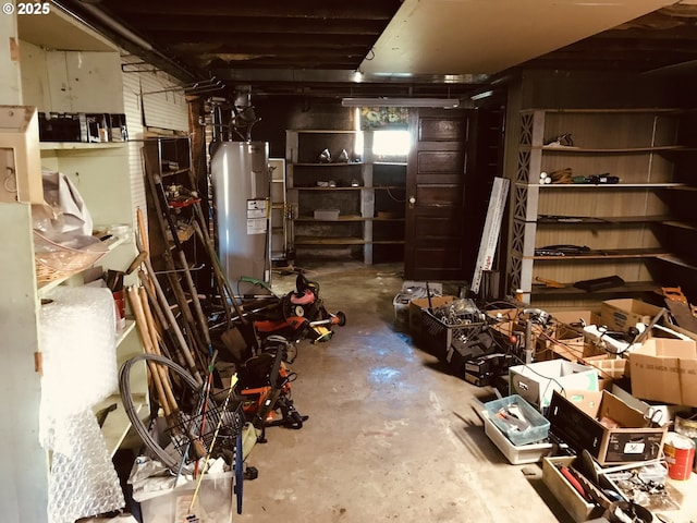 unfinished below grade area featuring electric water heater