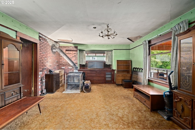 721 Columbia Blvd, Saint Helens, OR 97051 - carpeted living area with a wood stove, a chandelier, and brick wall