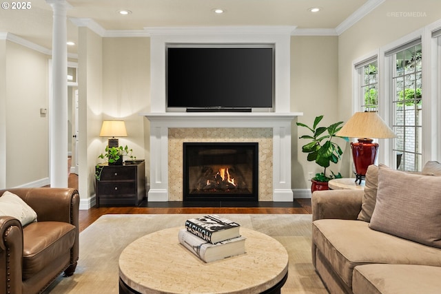 living room with recessed lighting, baseboards, a high end fireplace, crown molding, and wood finished floors