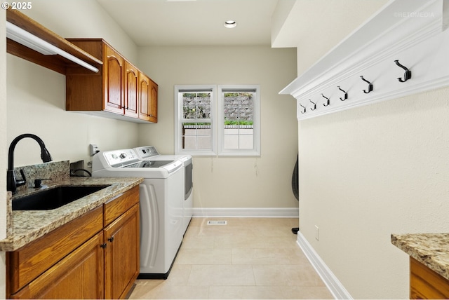 18462 Anduin Ter, Lake Oswego, OR 97034 - laundry room featuring cabinet space, separate washer and dryer, baseboards, light tile patterned floors, and recessed lighting