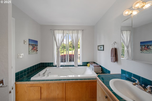 full bathroom featuring a garden tub and vanity