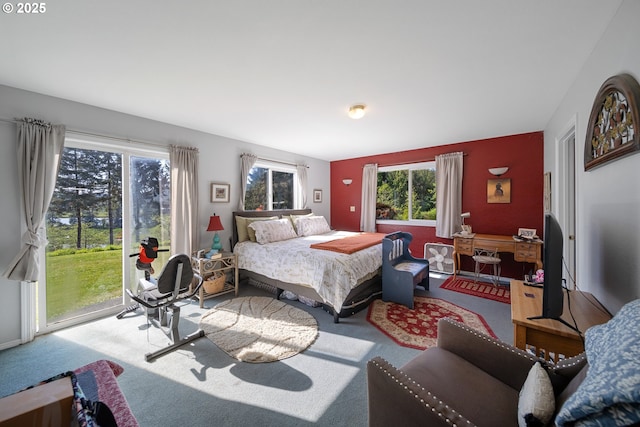 bedroom featuring access to exterior and carpet floors