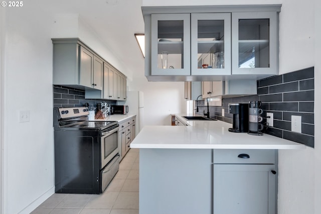 20700 SW Cherry Hill Rd, Sheridan, OR 97378 - kitchen featuring appliances with stainless steel finishes, gray cabinetry, tasteful backsplash, and glass insert cabinets