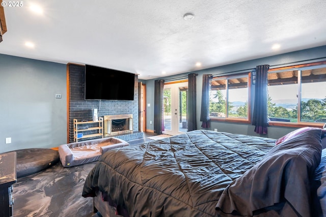 20700 SW Cherry Hill Rd, Sheridan, OR 97378 - bedroom with access to outside, a fireplace, recessed lighting, and a textured ceiling