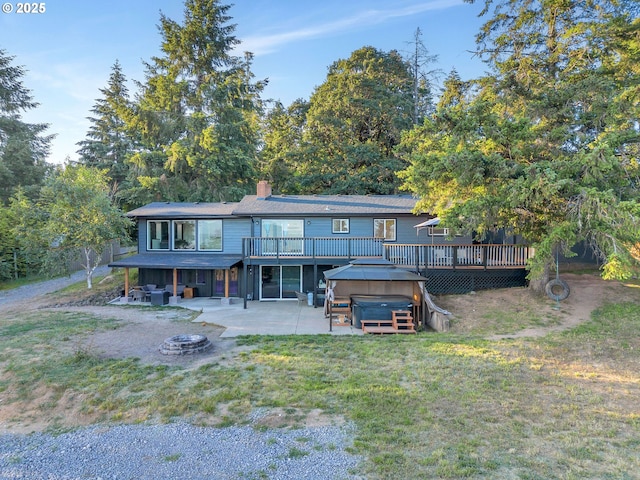 20700 SW Cherry Hill Rd, Sheridan, OR 97378 - back of house with a hot tub, a wooden deck, a patio, and an outdoor fire pit