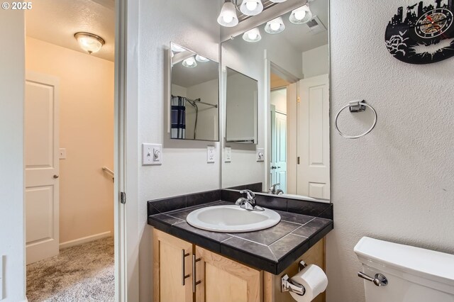 390 NW 116th Ave Unit 103, Portland, OR 97229 - bathroom featuring vanity and toilet
