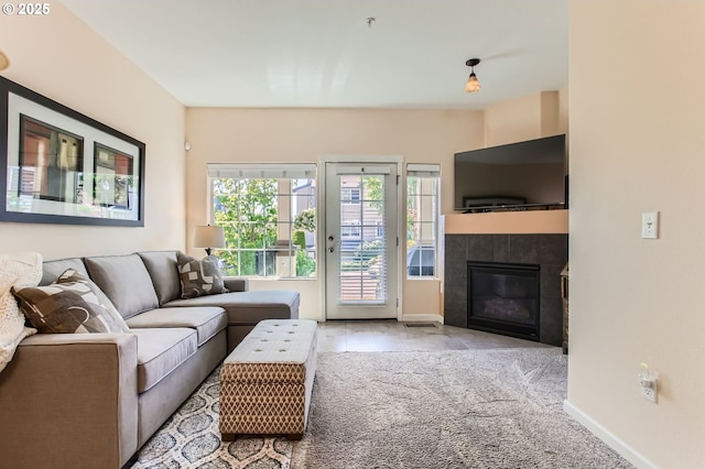 390 NW 116th Ave Unit 103, Portland, OR 97229 - carpeted living area featuring baseboards and a tile fireplace