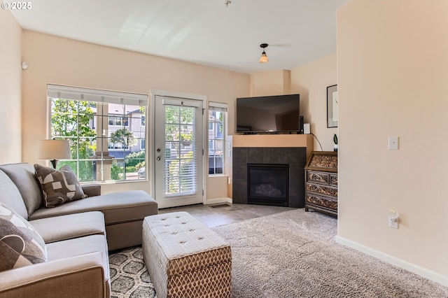 390 NW 116th Ave Unit 103, Portland, OR 97229 - living room featuring plenty of natural light, a fireplace, and carpet flooring