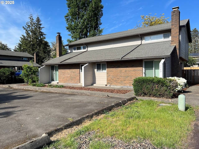5543 SW Lombard Ave, Beaverton, OR 97005 - view of front of home with a chimney, brick siding, and fence