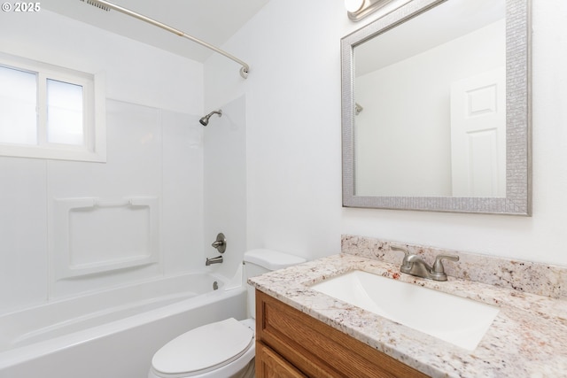 bathroom featuring toilet, shower / washtub combination, and vanity