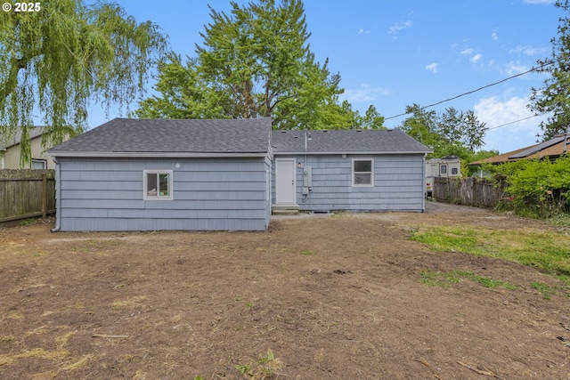 1489 Mckinley Ct, Eugene, OR 97402 - back of property featuring a fenced backyard and a shingled roof