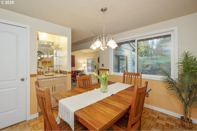 dining area featuring an inviting chandelier and light parquet floors