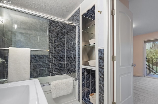 bathroom with enclosed tub / shower combo and a textured ceiling