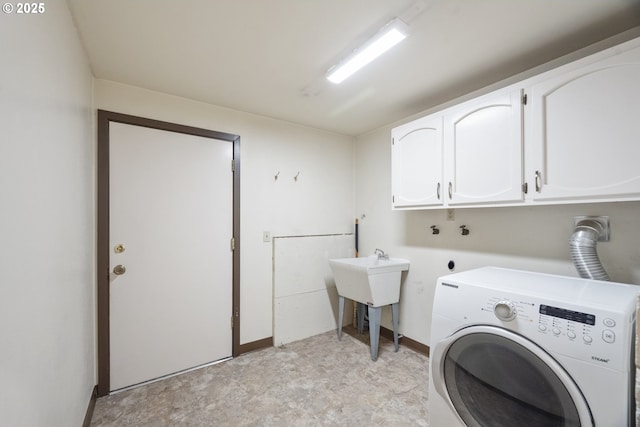 clothes washing area with cabinets and washer / dryer