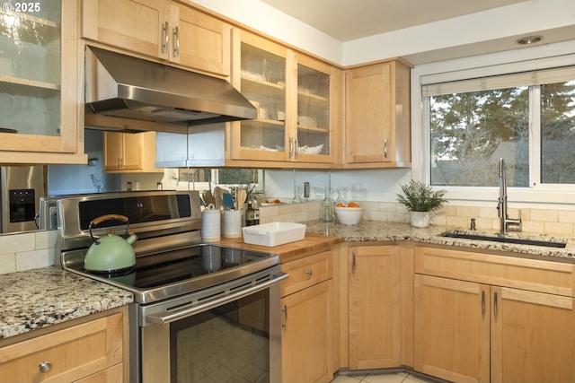 kitchen with light stone counters, sink, stainless steel electric range, and light brown cabinets