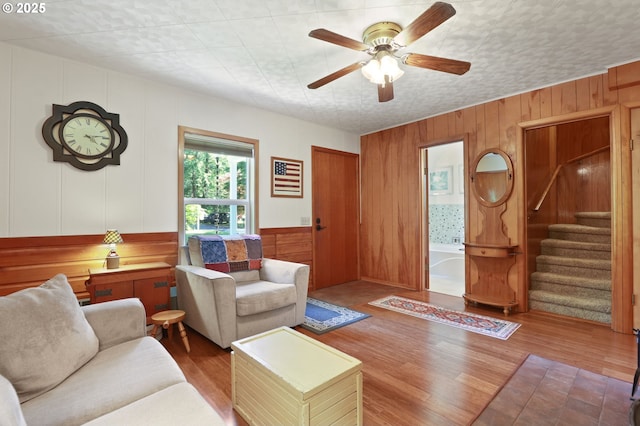 25701 S Morgan Rd, Estacada, OR 97023 - living room with wooden walls, wood finished floors, stairway, and ceiling fan