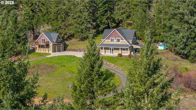 birds eye view of property featuring a wooded view