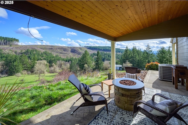 view of patio with a fire pit and central AC