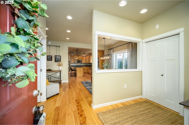 entrance foyer with light wood-style floors, recessed lighting, and baseboards