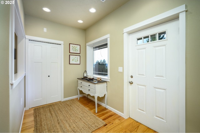 entrance foyer with baseboards, light wood finished floors, and recessed lighting