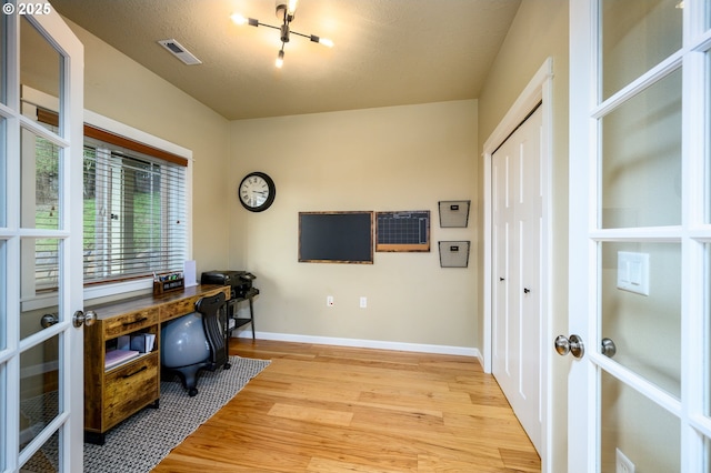 office featuring french doors, visible vents, baseboards, and light wood finished floors