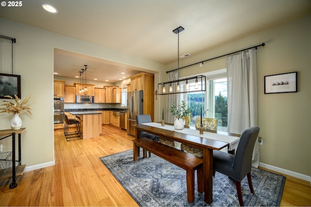 dining area with recessed lighting, visible vents, light wood-style flooring, and baseboards