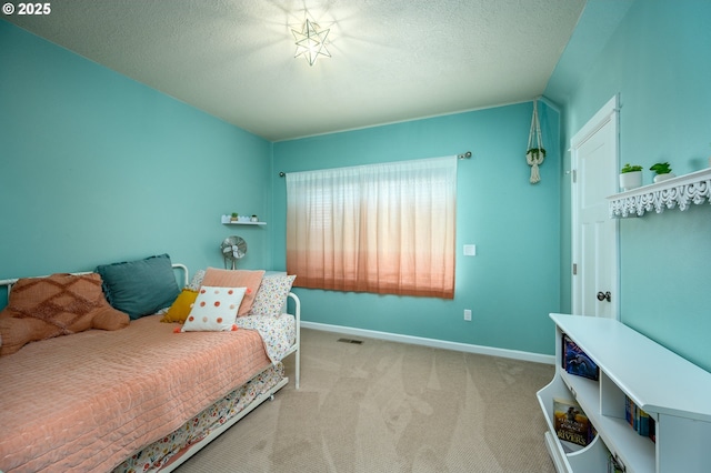 carpeted bedroom featuring visible vents, a textured ceiling, and baseboards