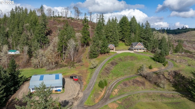 birds eye view of property featuring a view of trees