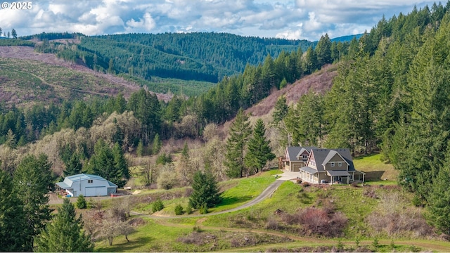 birds eye view of property featuring a view of trees