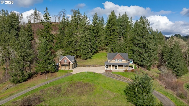 birds eye view of property featuring a wooded view