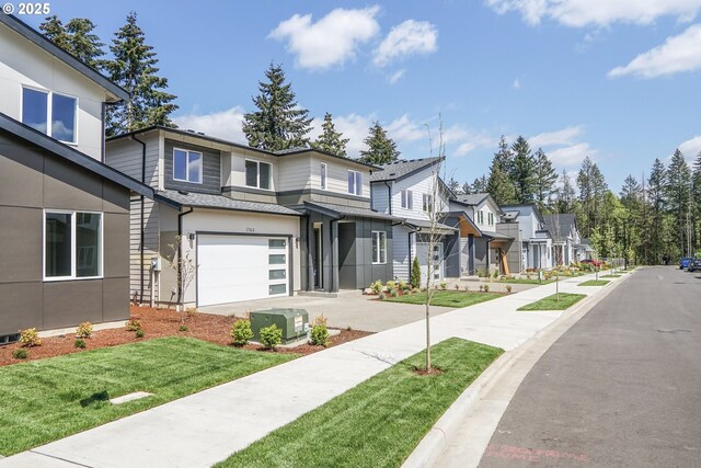 exterior space featuring a garage, a front lawn, a residential view, and concrete driveway