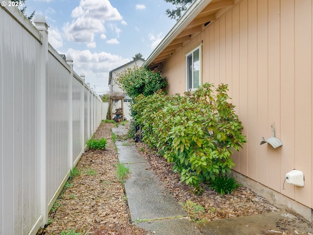 view of side of property featuring fence