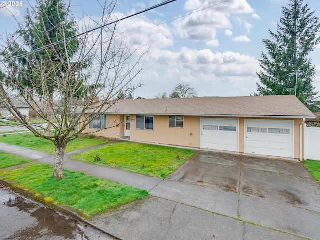 ranch-style home with concrete driveway, a front lawn, roof with shingles, and an attached garage