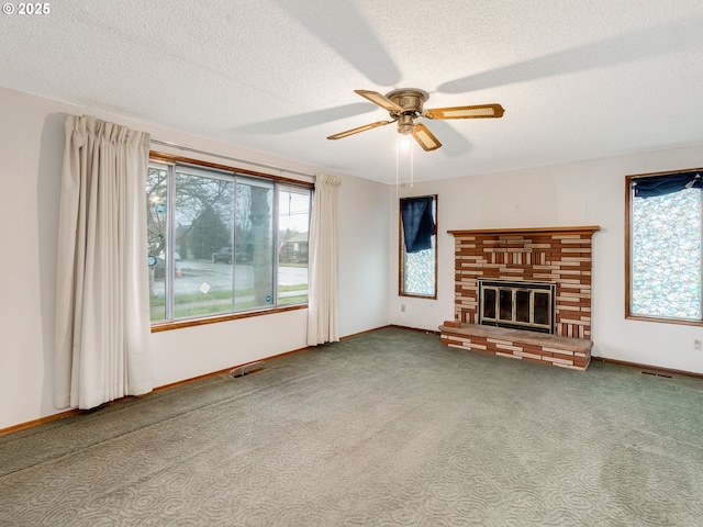 unfurnished living room featuring a textured ceiling, carpet floors, a brick fireplace, and visible vents