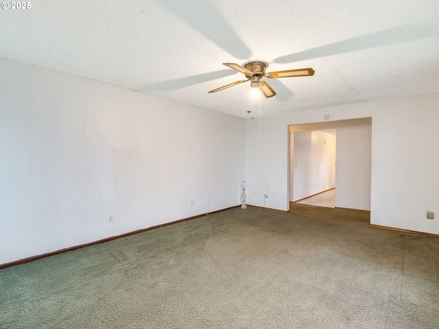 unfurnished room featuring light carpet, ceiling fan, a textured ceiling, and baseboards