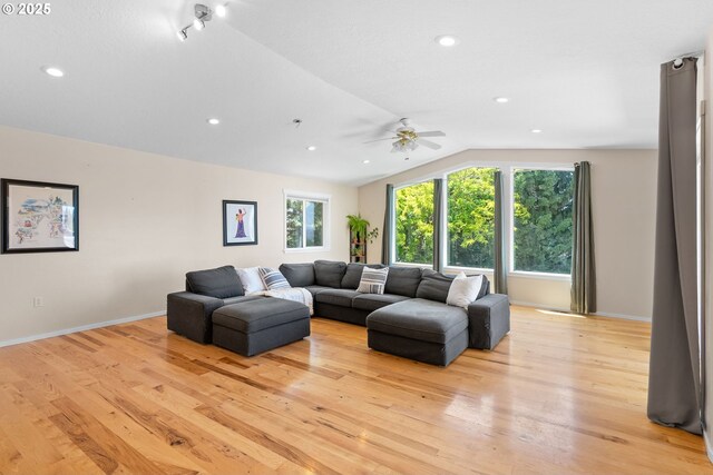 611 Summit Ridge Dr, The Dalles, OR 97058 - living room with lofted ceiling, light wood finished floors, a ceiling fan, recessed lighting, and baseboards