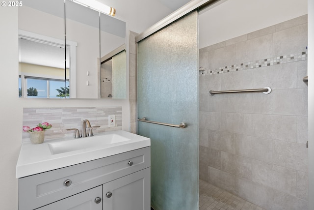 611 Summit Ridge Dr, The Dalles, OR 97058 - bathroom featuring a tile shower, vanity, and decorative backsplash