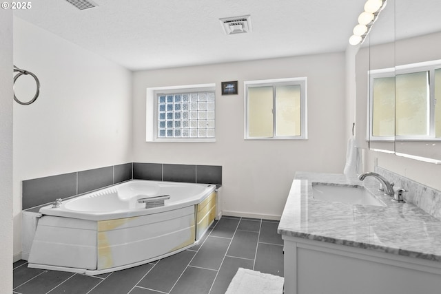611 Summit Ridge Dr, The Dalles, OR 97058 - bathroom featuring vanity, a bath, tile patterned floors, and baseboards