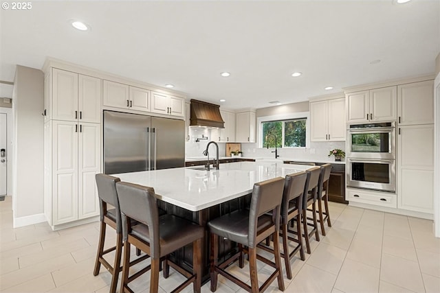 35001 NE 91st Ave, La Center, WA 98629 - kitchen featuring stainless steel appliances, premium range hood, tasteful backsplash, a breakfast bar, and recessed lighting