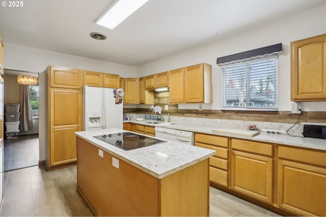 4314 SE 72nd Ave, Portland, OR 97206 - kitchen with white refrigerator with ice dispenser, black electric cooktop, a center island, a sink, and light stone countertops