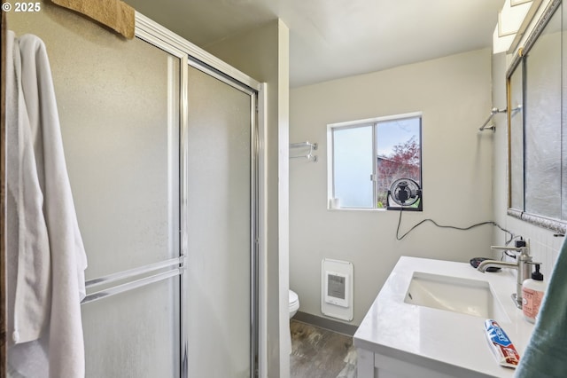 4314 SE 72nd Ave, Portland, OR 97206 - full bath featuring vanity, a shower stall, toilet, heating unit, and wood finished floors