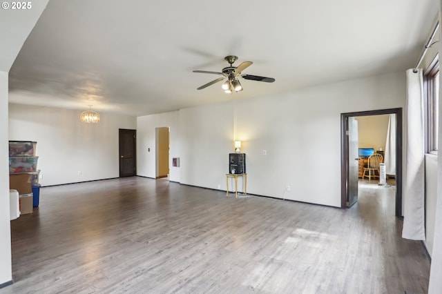 4314 SE 72nd Ave, Portland, OR 97206 - unfurnished living room with a ceiling fan, wood finished floors, a chandelier, and baseboards