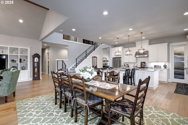 dining area featuring light hardwood / wood-style floors and lofted ceiling