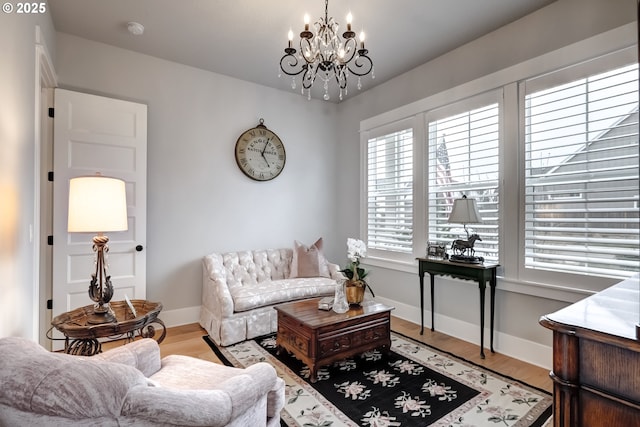 living room with light hardwood / wood-style flooring and a notable chandelier