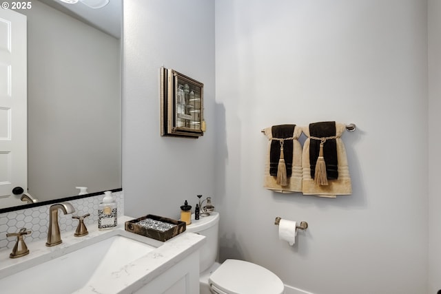 bathroom featuring toilet and vanity