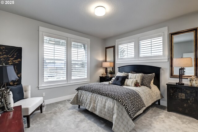 bedroom featuring light colored carpet