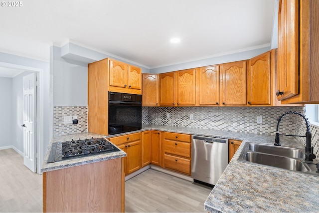 kitchen with black appliances, decorative backsplash, light hardwood / wood-style floors, and sink