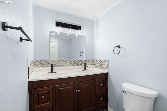 bathroom with vanity, tasteful backsplash, toilet, and crown molding